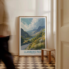 Framed Llanberis Pass travel poster with mountain landscape art leaning on floor