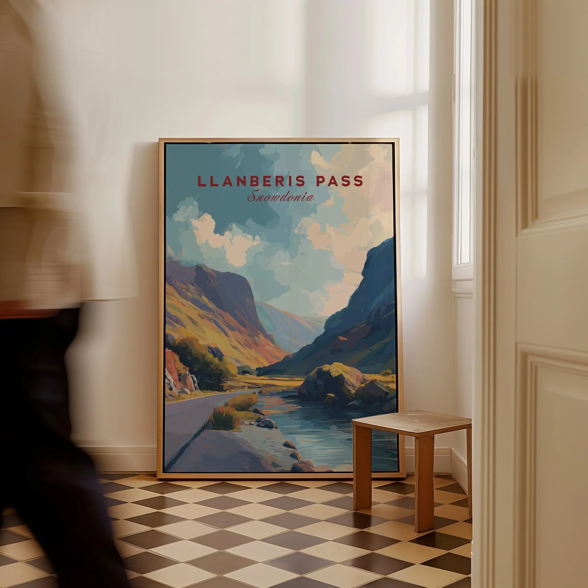 Framed Llanberis Pass Snowdonia travel poster leaning on wall in modern hallway