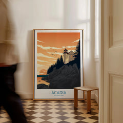 Framed Acadia National Park print with lighthouse and sunset, leaning against wall in hallway