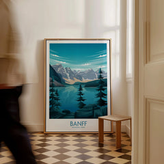 Framed Banff National Park art print with mountain and lake scene on floor by window