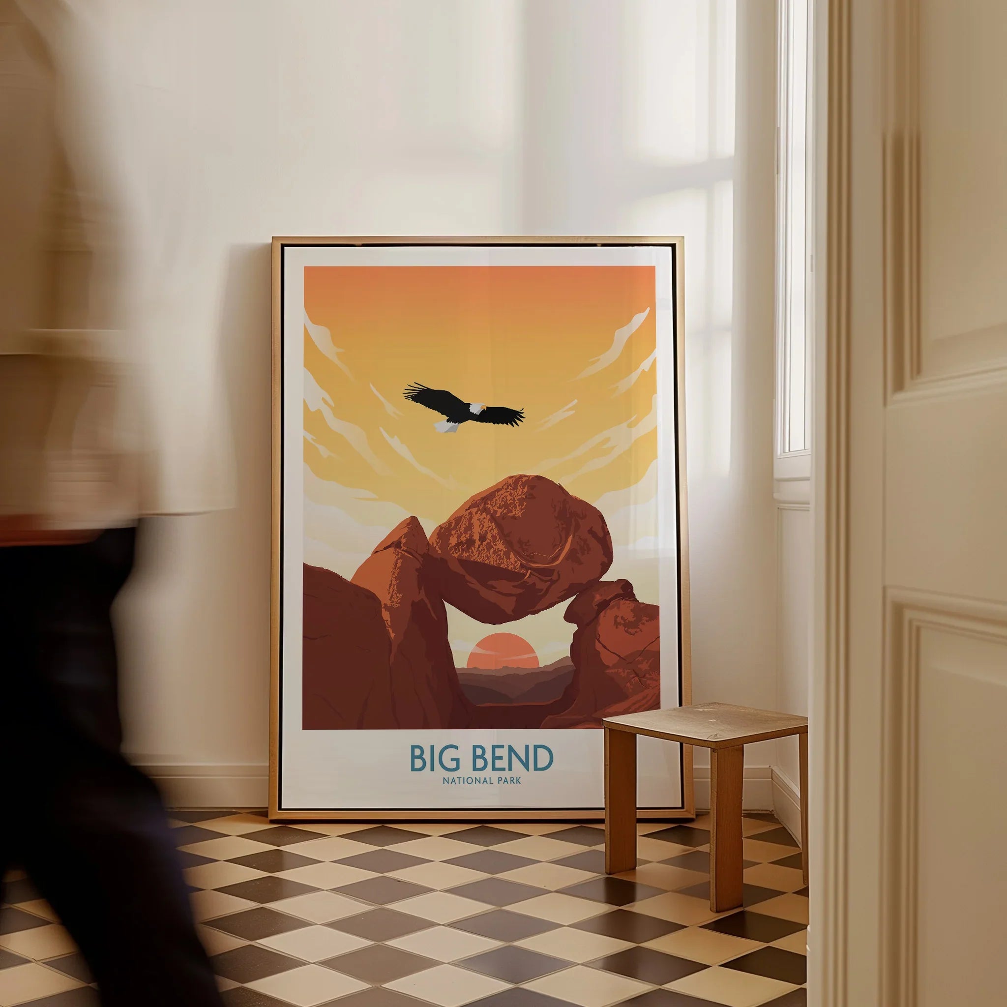 Framed Big Bend National Park travel poster with eagle and desert rocks on floor in bright hallway