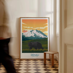 Framed Denali National Park poster with bear and mountains, leaning on wall in bright room