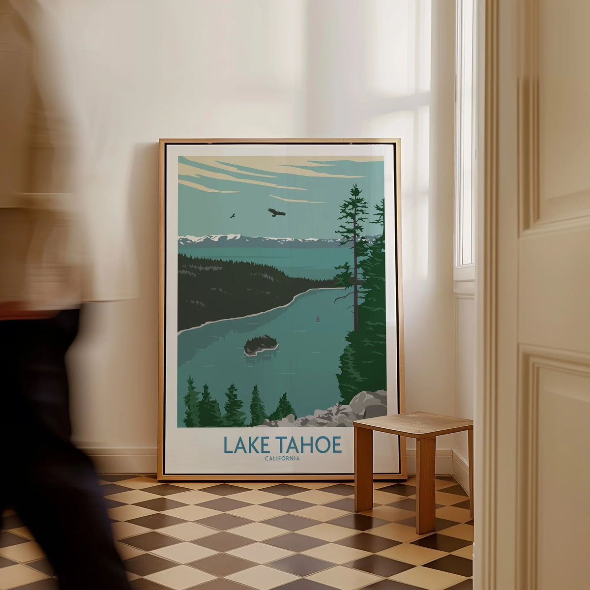 Lake Tahoe framed travel poster with nature art on floor in bright hallway