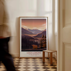Framed Loch Lomond National Park travel poster on floor in bright hallway with man walking by