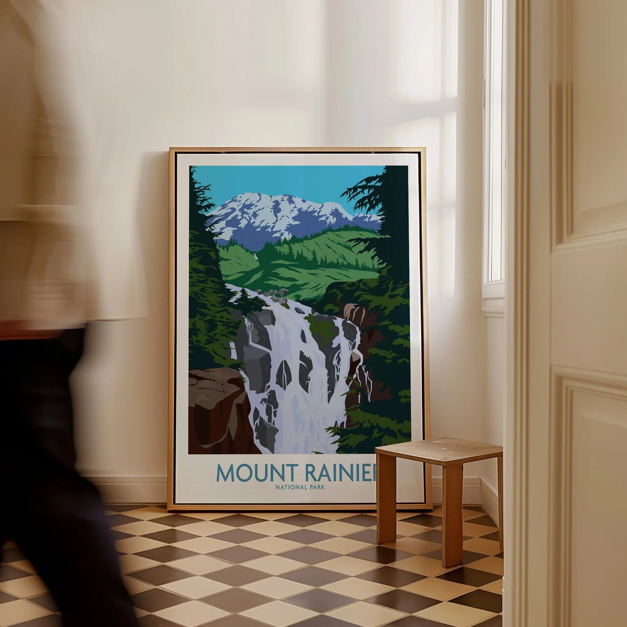 Framed Mount Rainier National Park art print with waterfall on floor in modern hallway