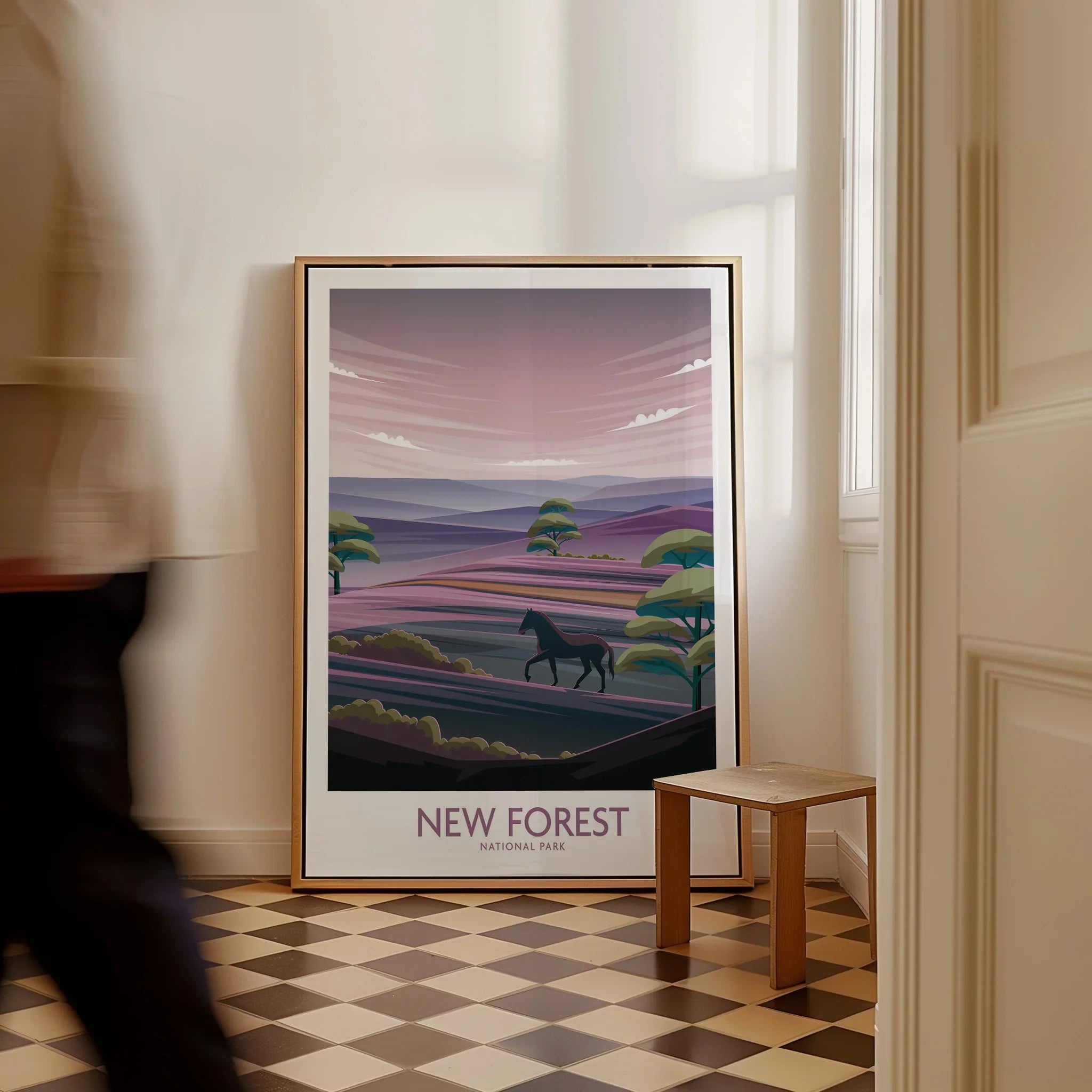 Framed New Forest National Park art print with horse on floor, man walking past in hallway