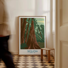 Framed Sequoia National Park poster with redwood trees on floor, man walking past in hallway.