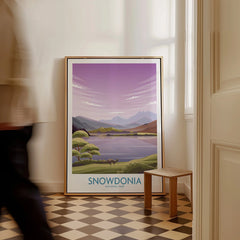 Framed Snowdonia National Park travel poster leaning on floor in bright entryway