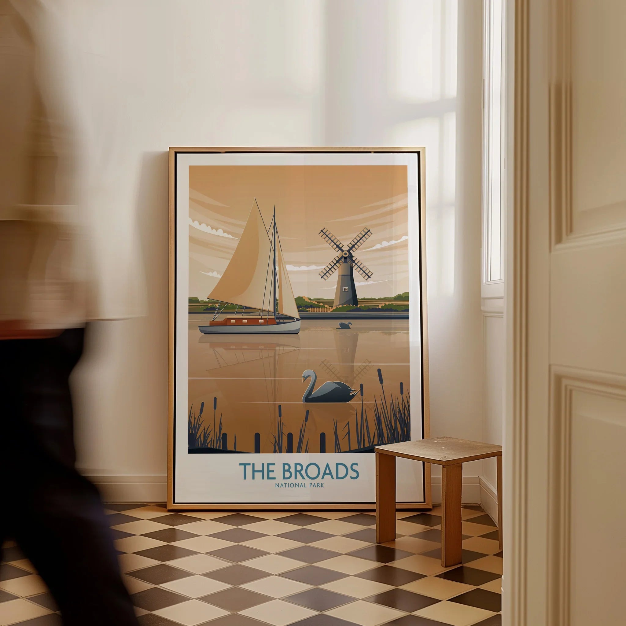 Framed The Broads National Park travel poster with sailboat, windmill, and swan, in hallway