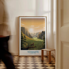 Framed Yosemite National Park travel poster with sunset landscape on floor, man walking past.
