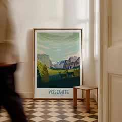 Framed Yosemite National Park art print on floor in bright hallway, man walking past