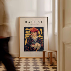 Matisse Art Prints -  Woman in Patterned Hat & Dress Poster displayed in a stylish interior setting.