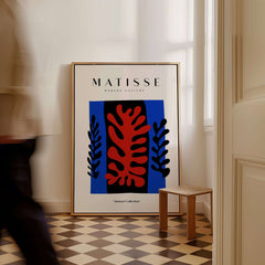 Matisse Art Prints -  Red Coral Black Leaves Blue Frame Poster displayed in a stylish interior setting.