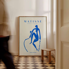 Matisse Art Prints -  Blue Nude Seated Figure Poster displayed in a modern interior with a beige background.