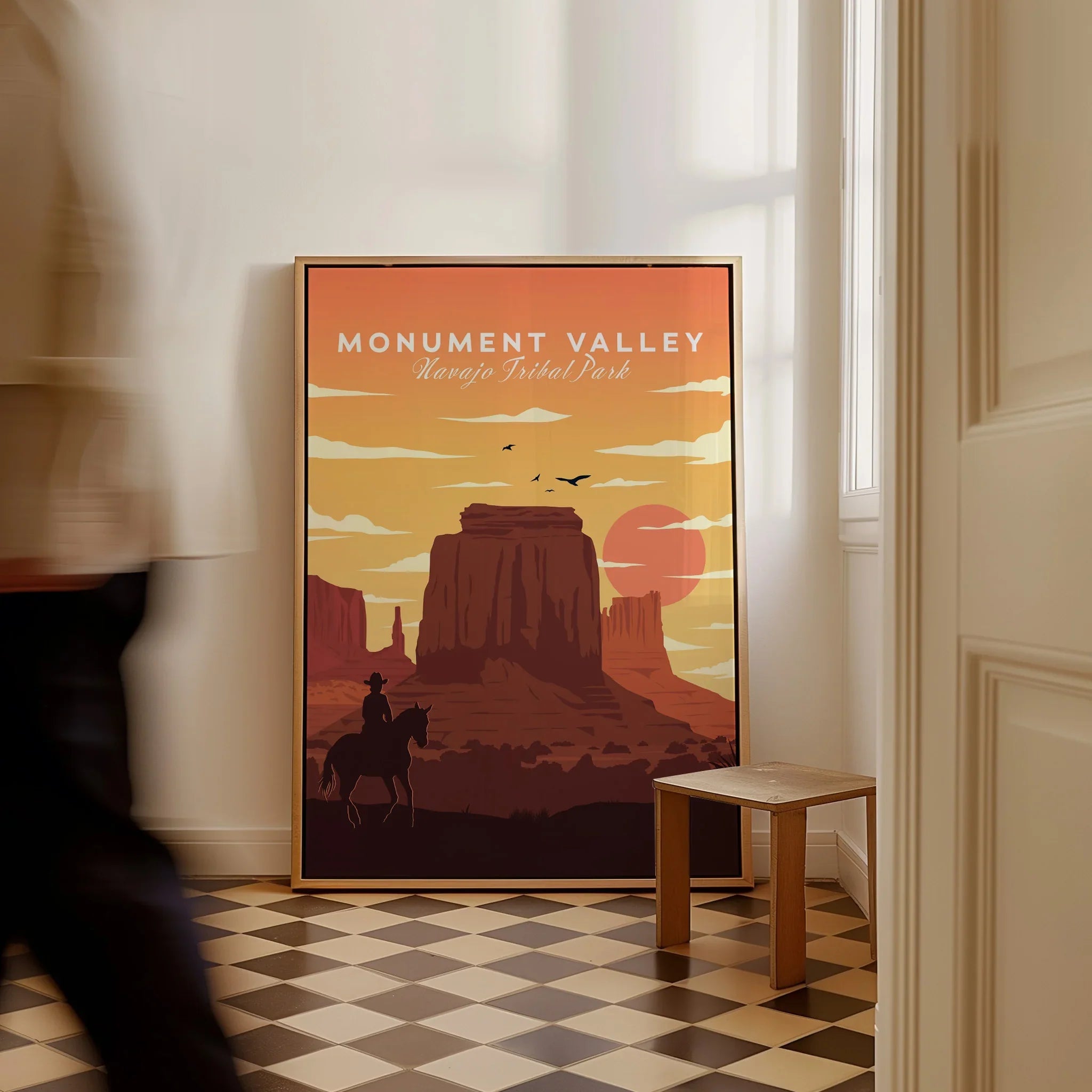 Framed Monument Valley Navajo Tribal Park travel poster with desert sunset artwork on floor