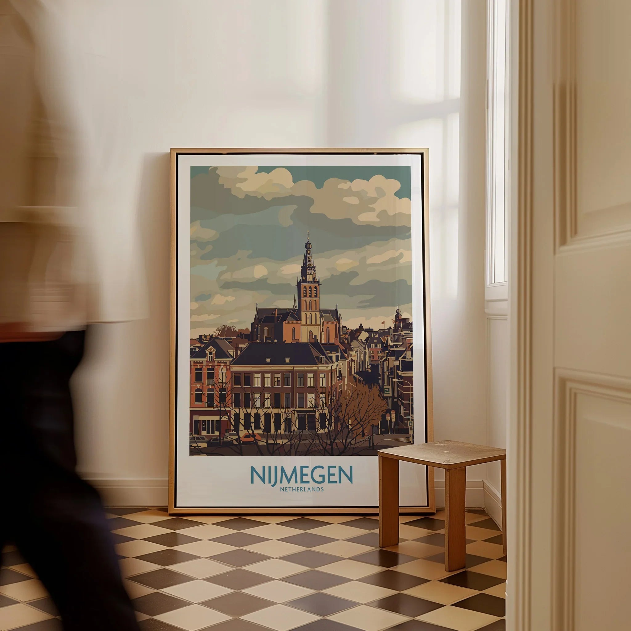 Framed Nijmegen Netherlands city skyline wall art on checkered floor, person walking past