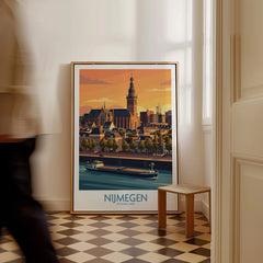 Framed Nijmegen Netherlands travel poster with city skyline leaning on floor, man walking past.