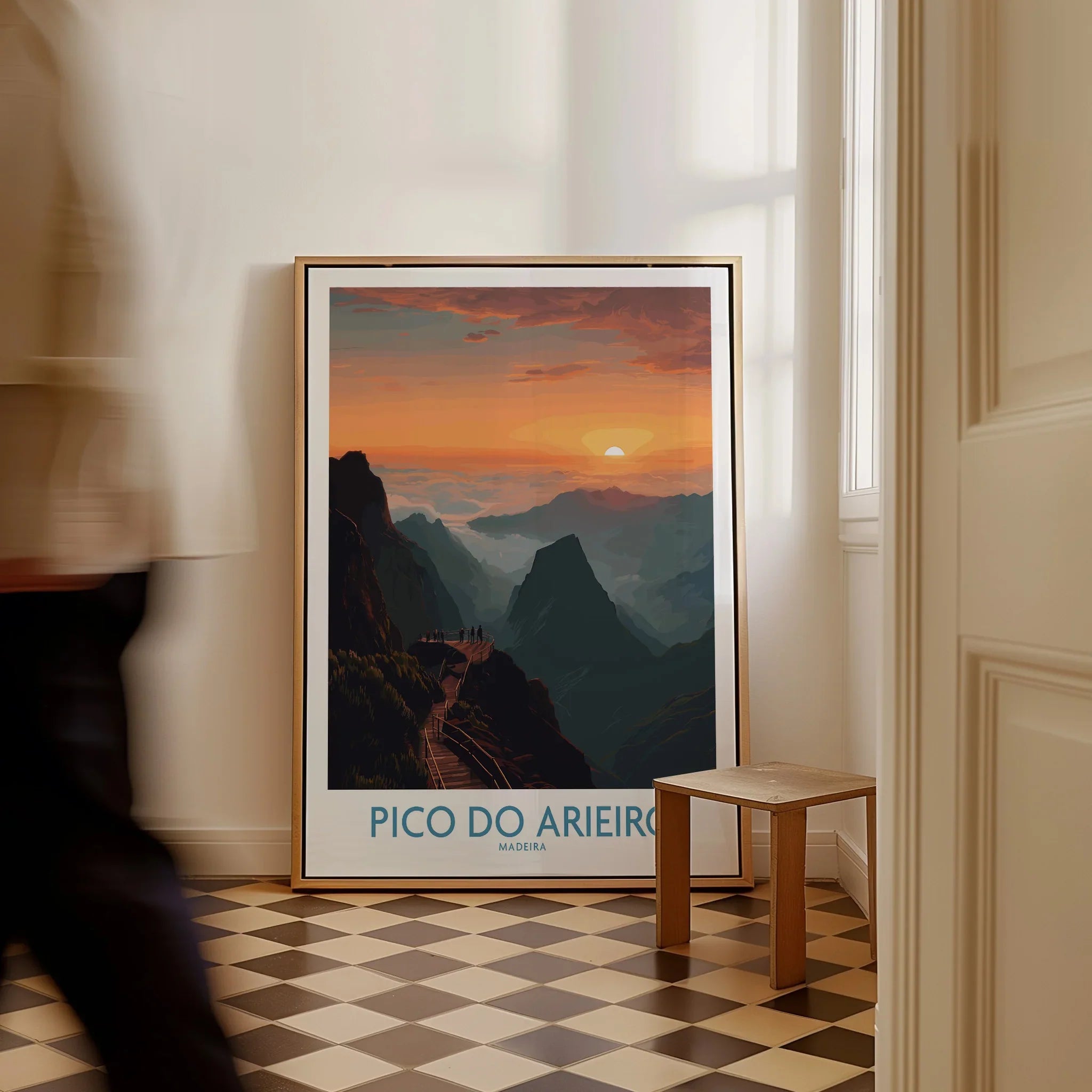 Framed Pico do Arieiro Madeira travel poster on floor in sunlit room, man walking past