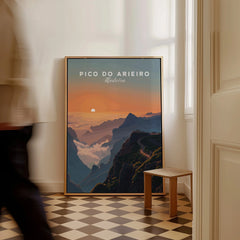 Framed Pico do Arieiro Madeira travel poster on floor in sunlit room, man walking past