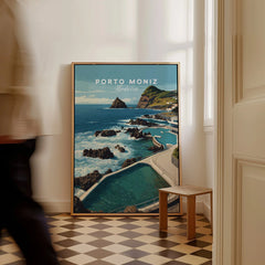 Framed Porto Moniz Madeira travel poster with ocean view on floor in bright hallway