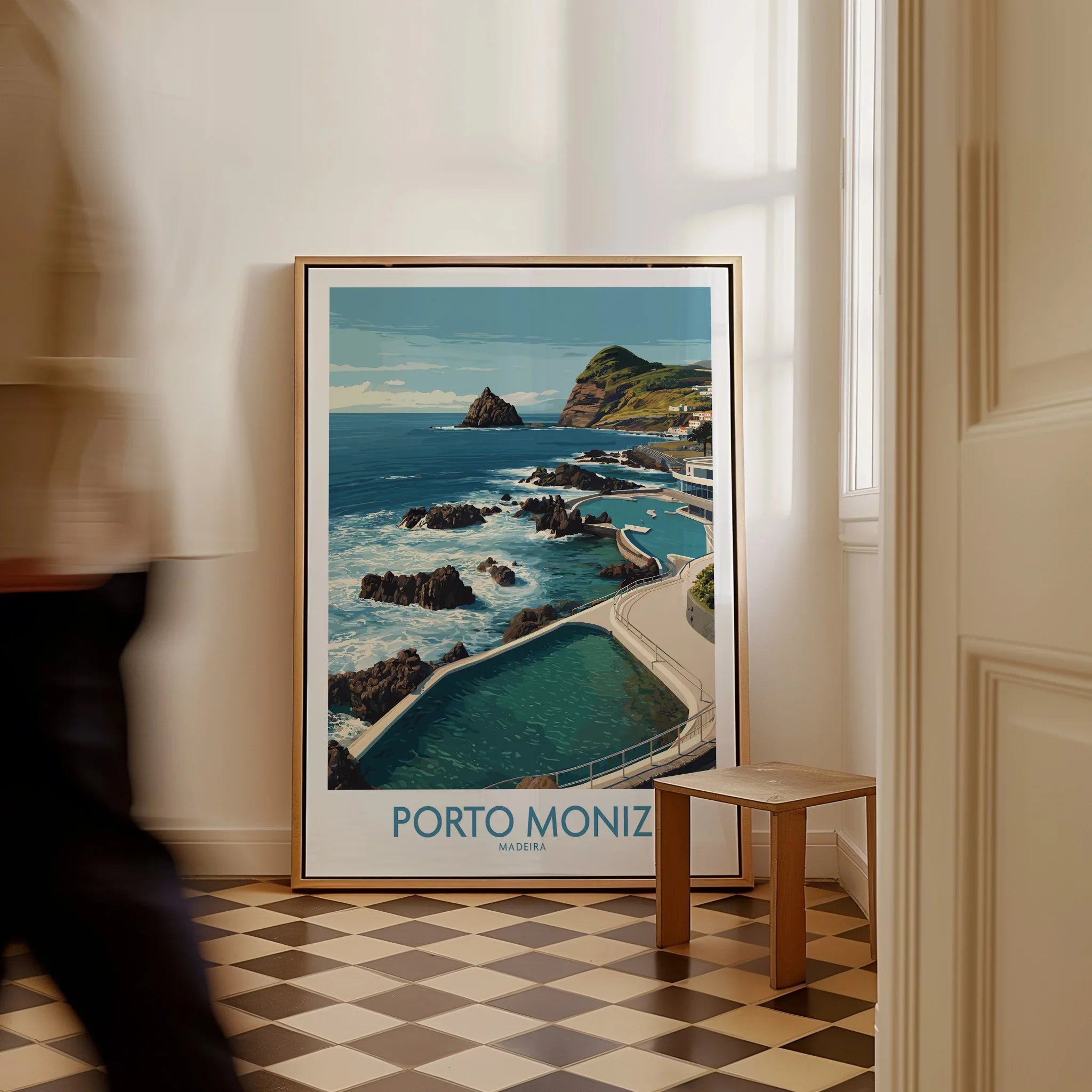 Framed Porto Moniz Madeira travel poster on floor in stylish home interior