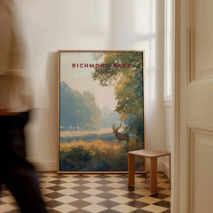 Richmond Park framed travel poster with deer and nature scene on floor in modern hallway