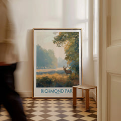 Framed Richmond Park art print leaning on wall, man walking by in modern hallway