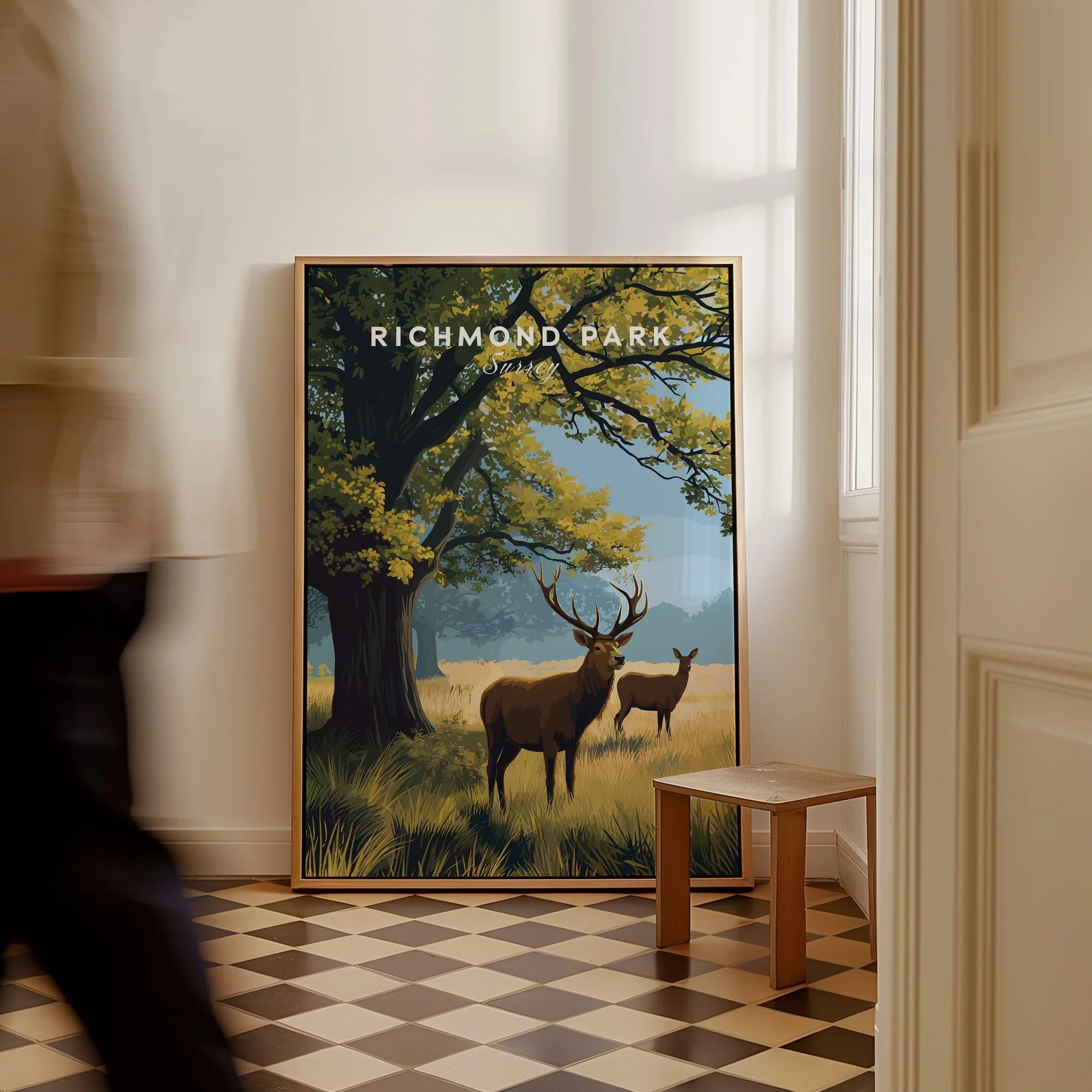 Richmond Park travel poster print featuring deer in a scenic landscape, framed on floor.