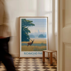 Framed Richmond Park art print with deer and landscape, leaning on floor in modern hallway