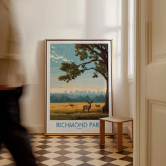 Framed Richmond Park travel poster with deer and tree on floor in bright hallway