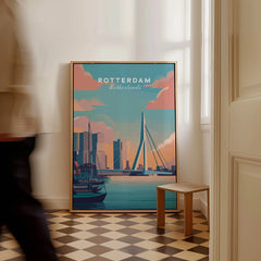 Framed Rotterdam Netherlands travel poster with city skyline and bridge, on checkered floor.