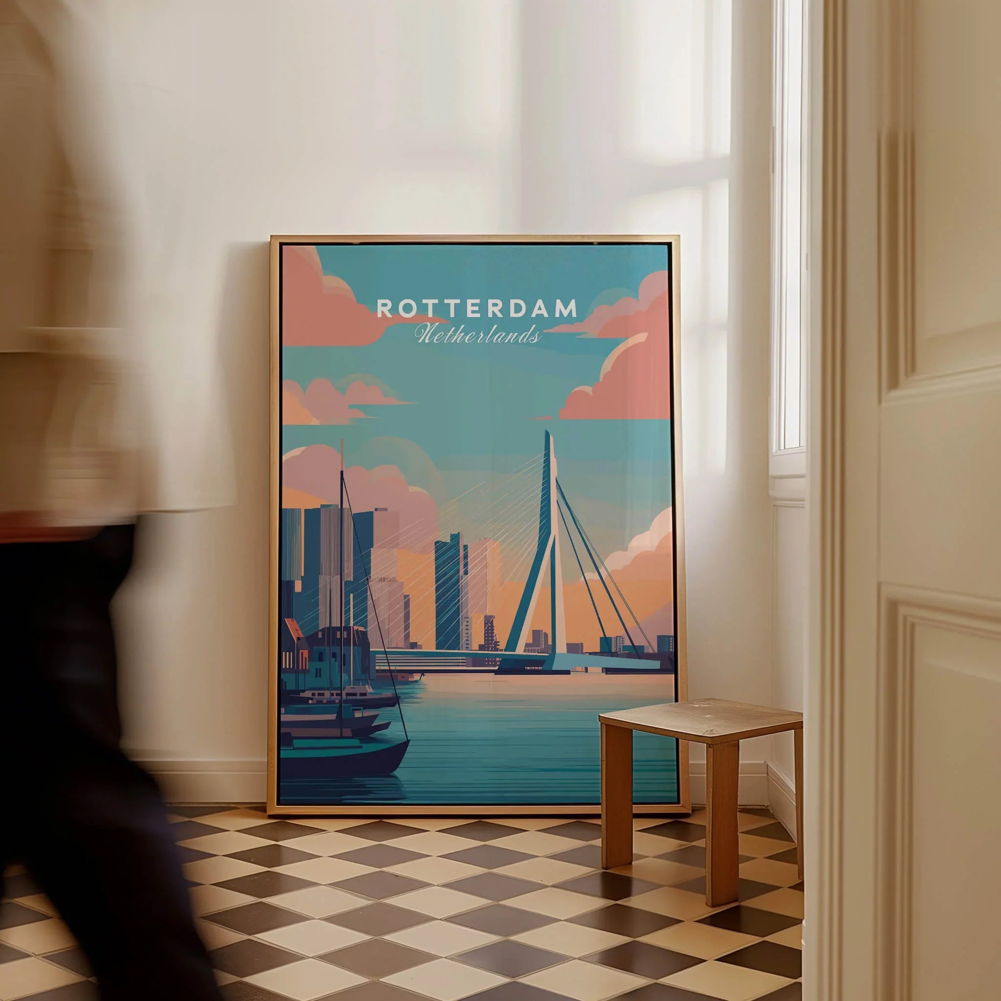 Framed Rotterdam Netherlands travel poster with city skyline and bridge, on checkered floor.