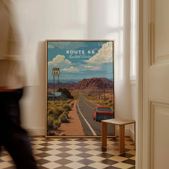 Framed Route 66 travel poster with red car and desert landscape on checkered floor