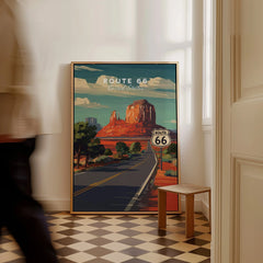 Framed Route 66 travel poster with desert landscape leaning on wall in modern home