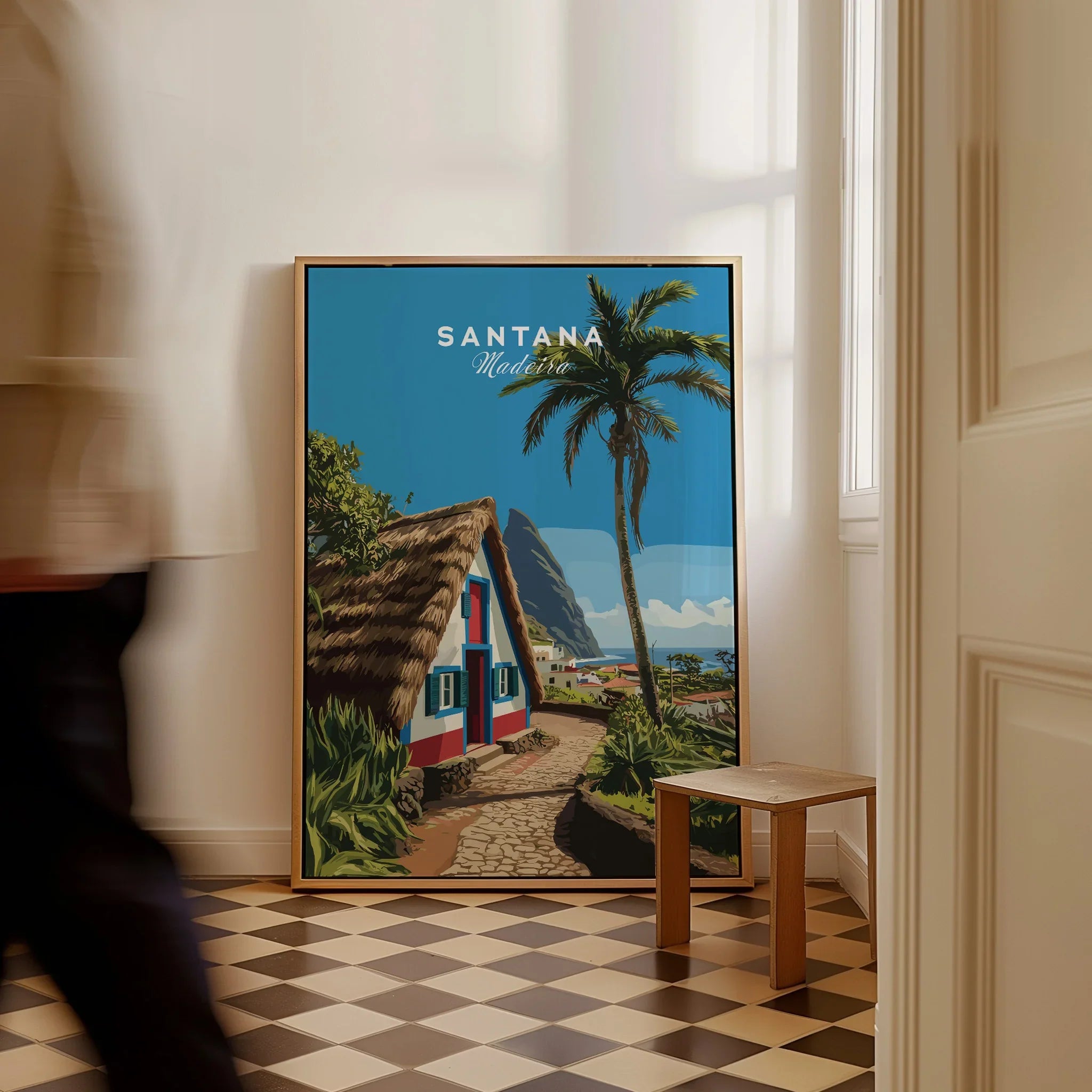 Framed Santana Madeira travel poster on floor, tropical home decor, man walking past