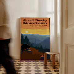 Framed Great Smoky Mountains National Park art print on floor, man walking past in hallway.
