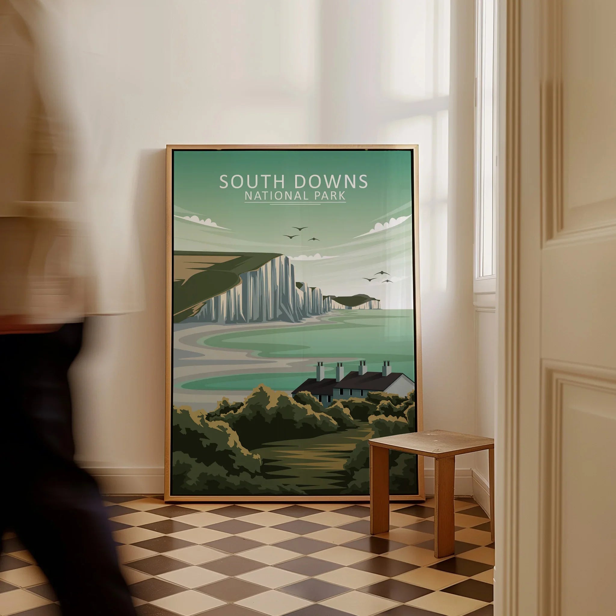 Framed South Downs National Park travel poster on floor in modern hallway interior