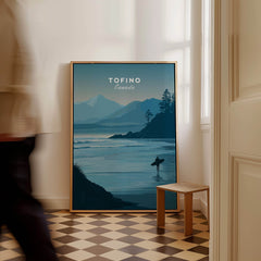 Tofino Canada Travel Poster | Pacific Coast Surfer Wall Art Print displayed in a modern interior with a person passing by.