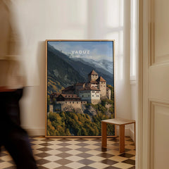 Framed Vaduz Liechtenstein travel poster leaning on wall with mountains and castle art