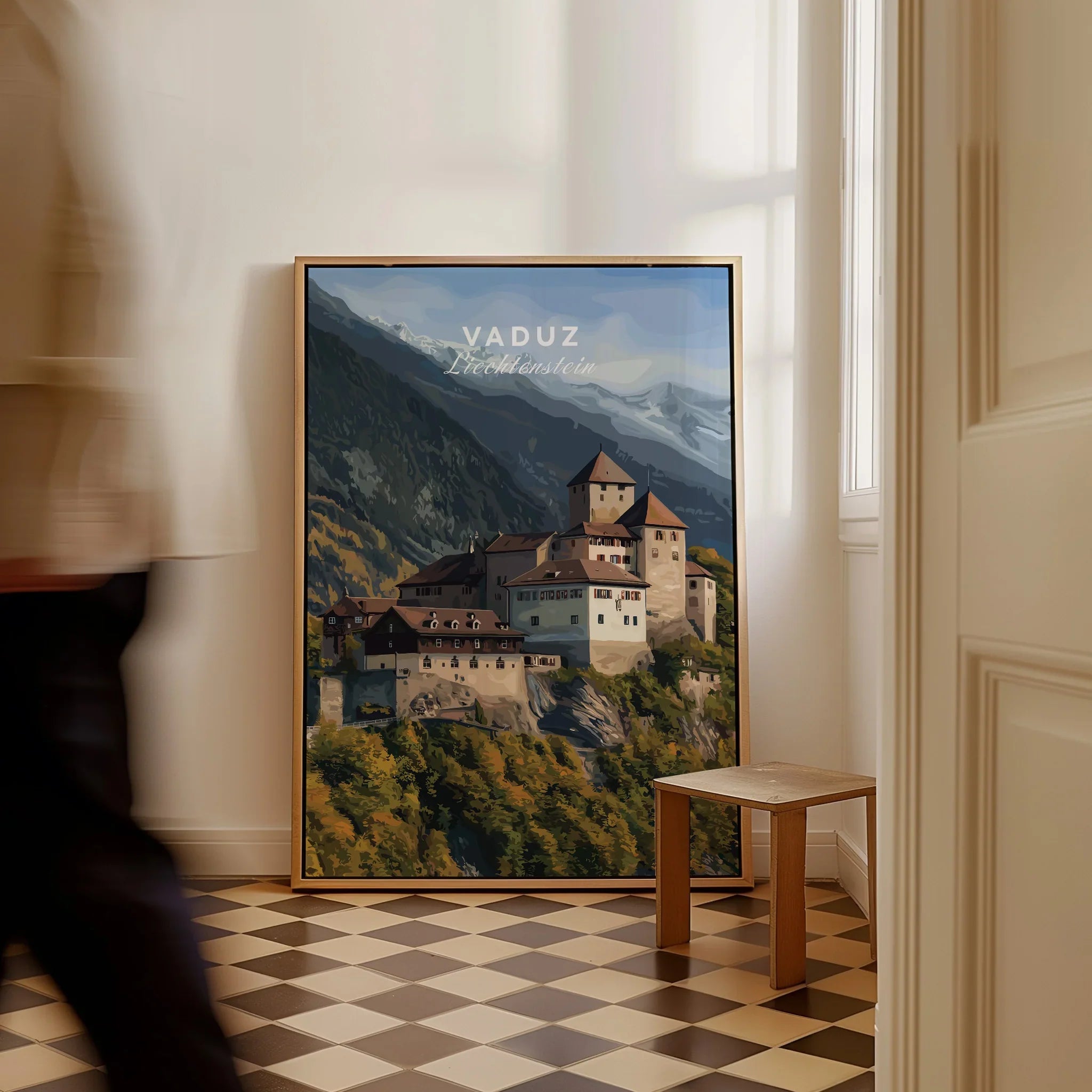Framed Vaduz Liechtenstein travel poster leaning on wall with mountains and castle art