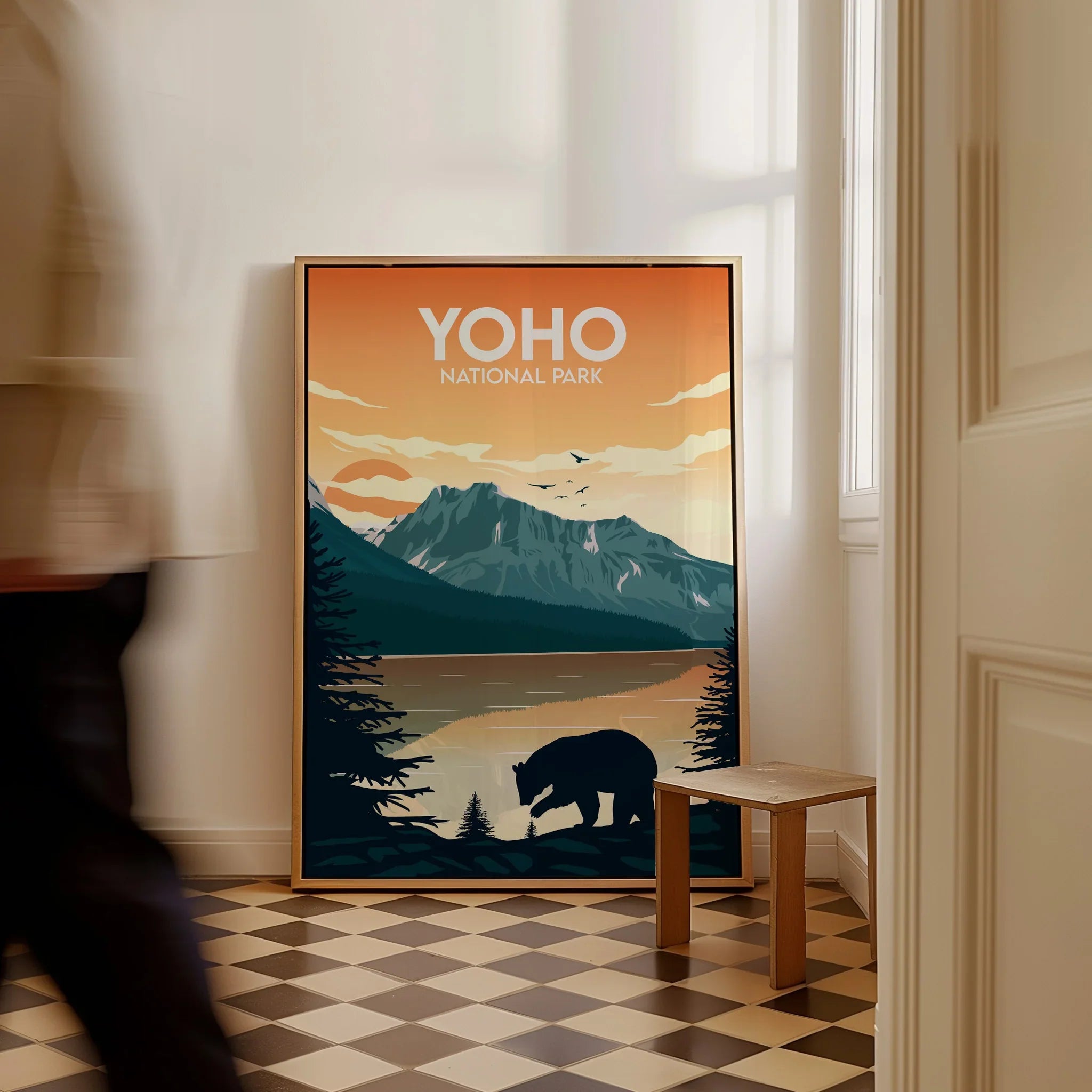 Framed Yoho National Park travel poster with mountain, lake, and bear, leaning on floor