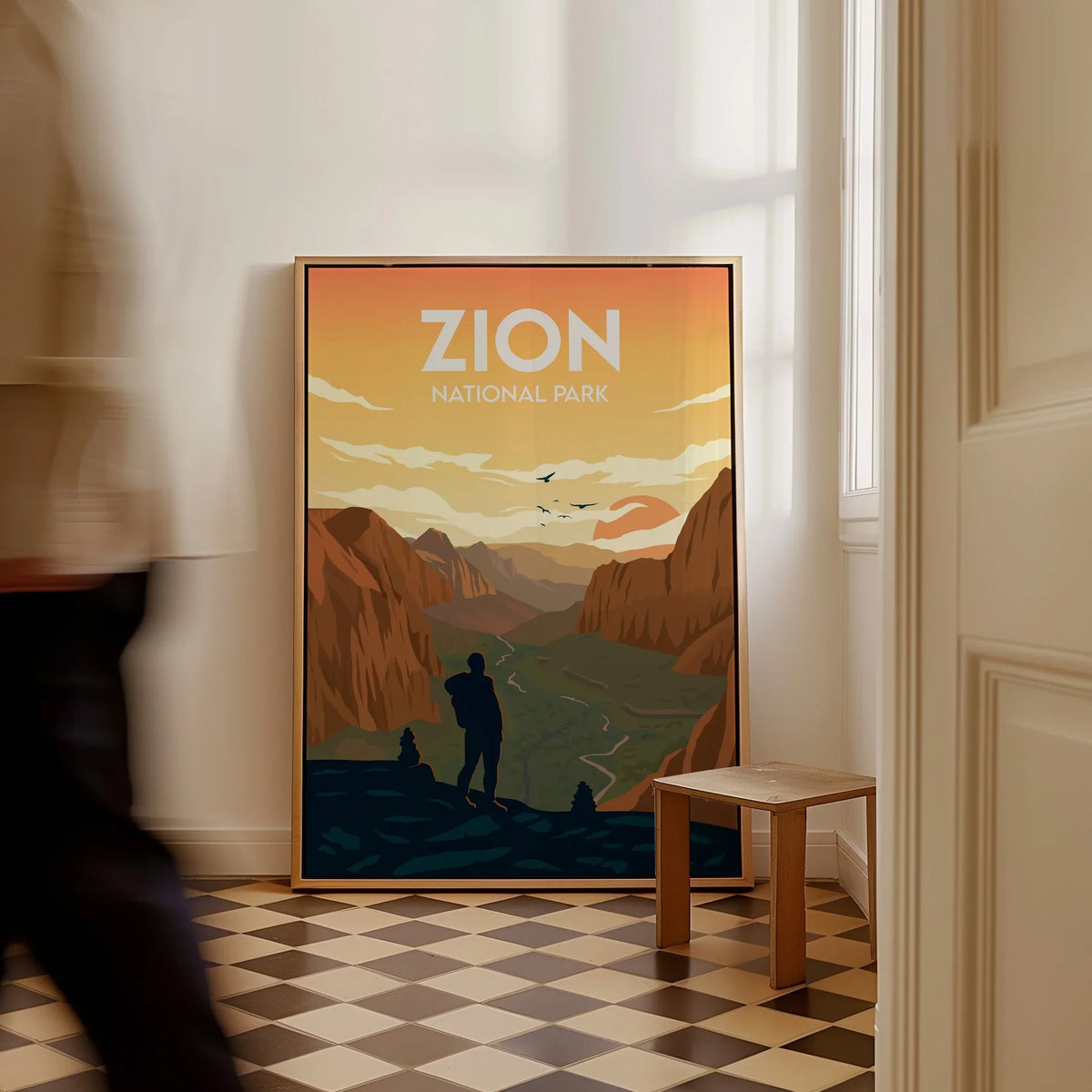 Zion National Park travel poster with hiker, framed print on floor in bright room