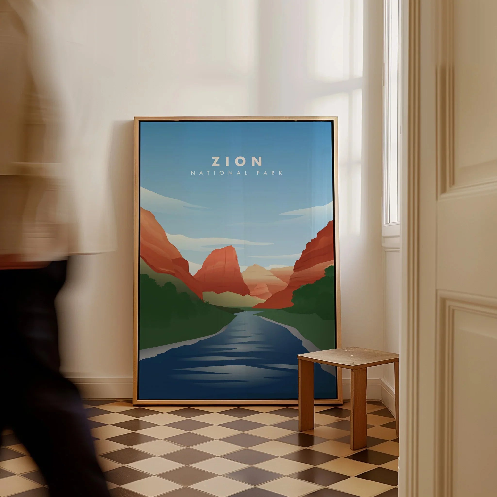 Framed Zion National Park travel poster on floor in bright room with checkered tile