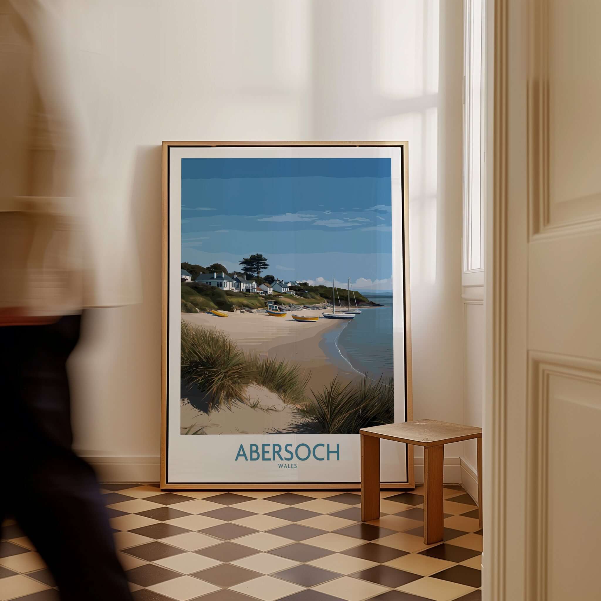 Abersoch Wales Sand Dunes Beach Art Print | Sailboats Coastal Wall Decor displayed in an interior setting with a person walking by.
