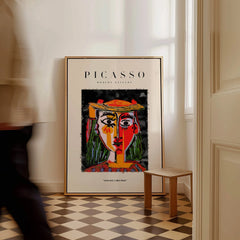 Picasso Woman in Hat Red Yellow Face Portrait Poster Colorful Abstract Artwork Print displayed in a stylish interior.