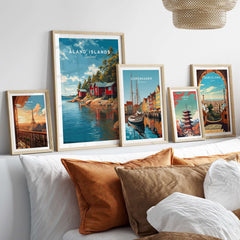 Åland Islands Picturesque Nordic Huts Print | Scandinavian Travel Wall Decor framed artworks displayed on a cozy bed.