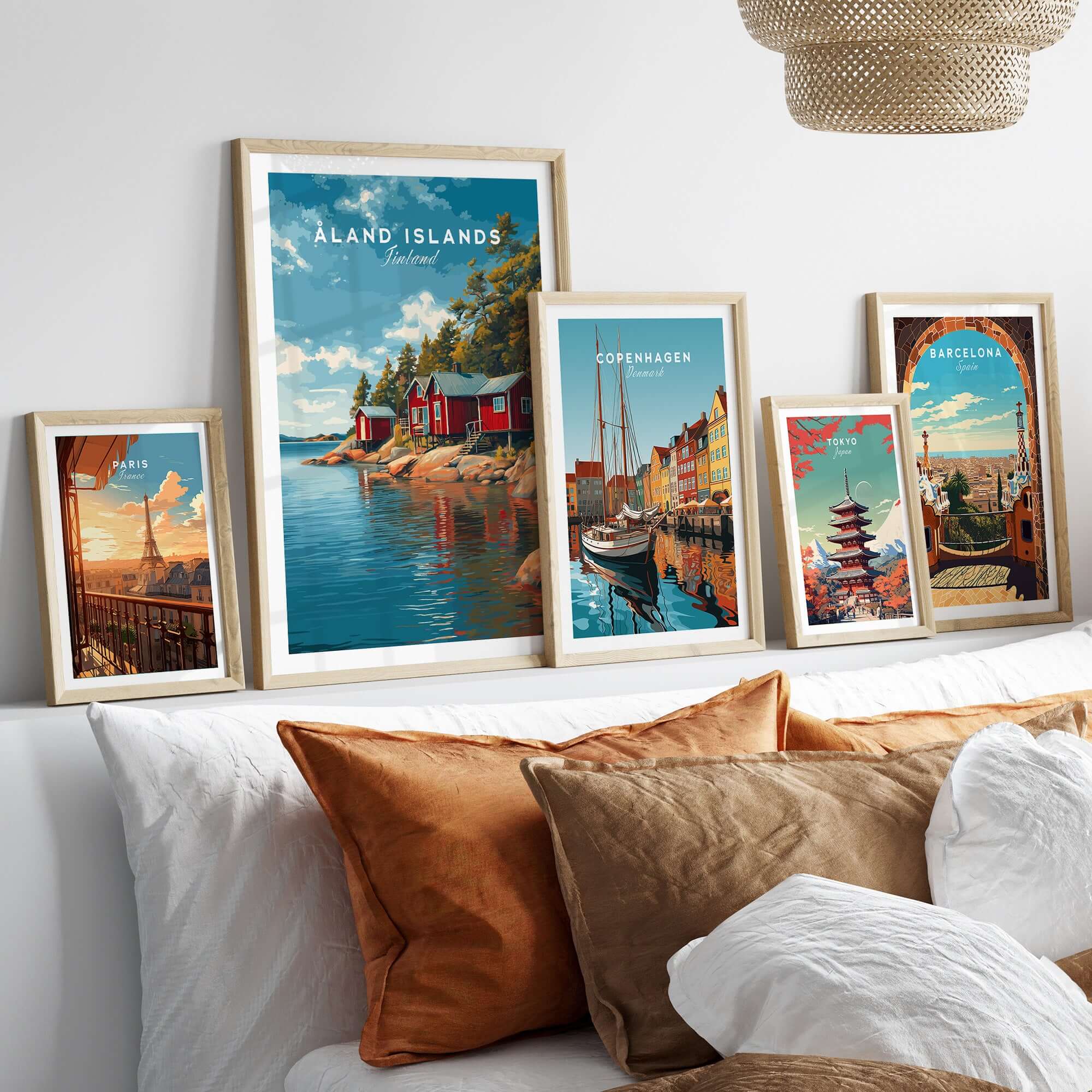 Åland Islands Picturesque Nordic Huts Print | Scandinavian Travel Wall Decor framed artworks displayed on a cozy bed.