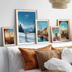 Gallery of scenic travel wall art including Alta Utah skis and global cityscapes, displayed over cozy bedding.