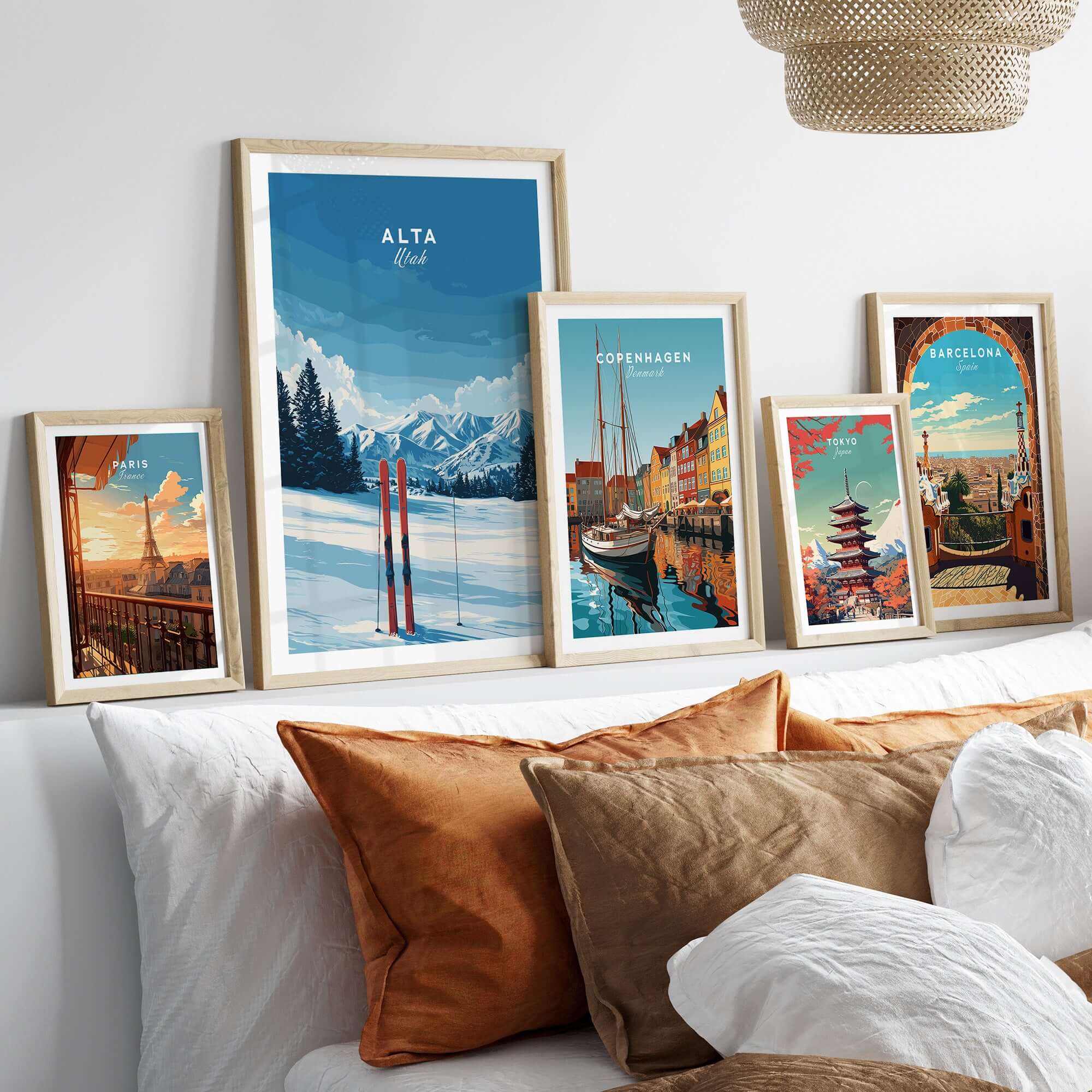 Gallery of scenic travel wall art including Alta Utah skis and global cityscapes, displayed over cozy bedding.