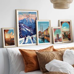 Framed posters of Alta Utah, Copenhagen, and Barcelona on a cozy bed, showcasing travel wall art.